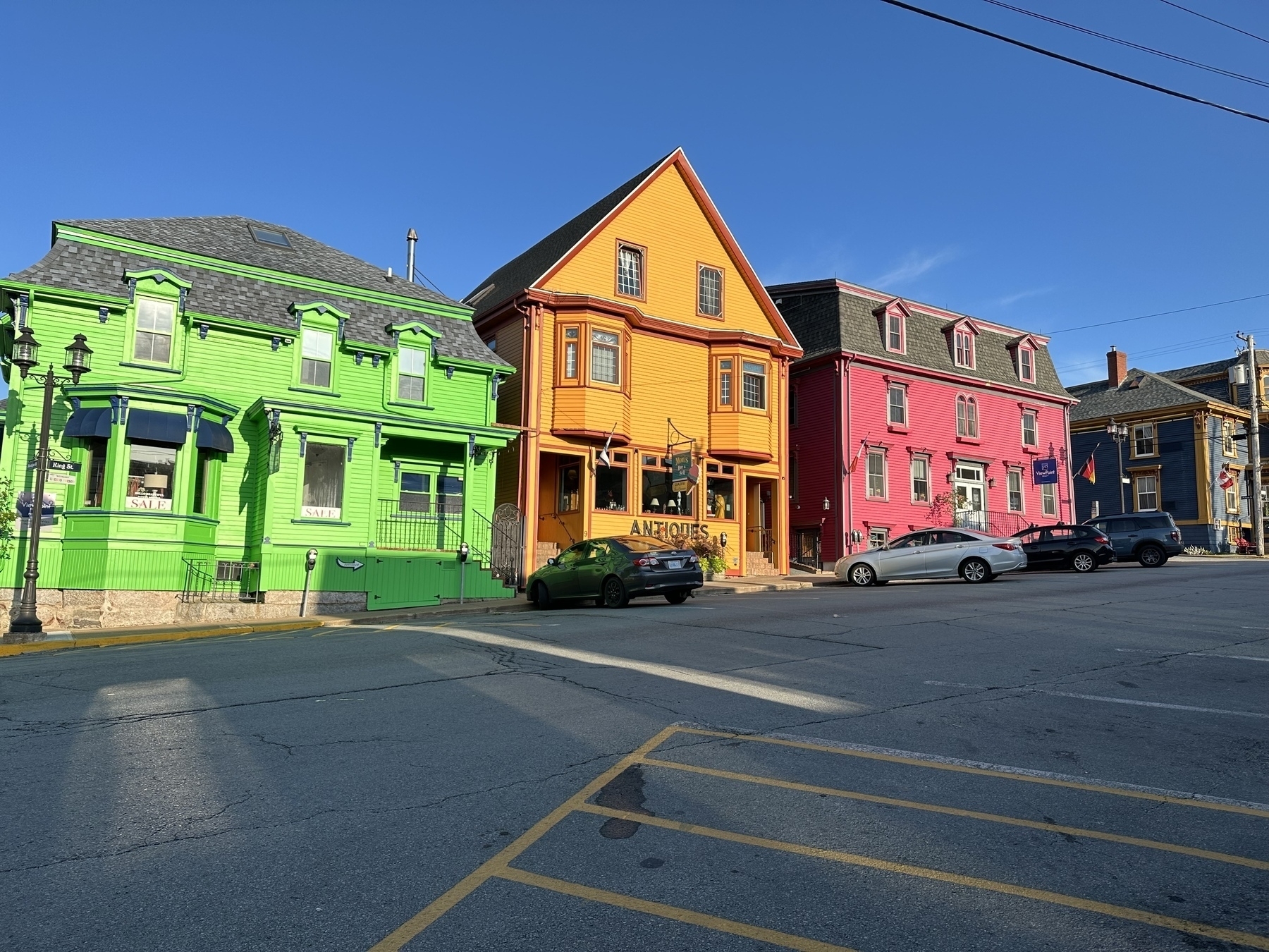 A green, orange, and pink house along a street in Lunenburg, Nova Scotia. 